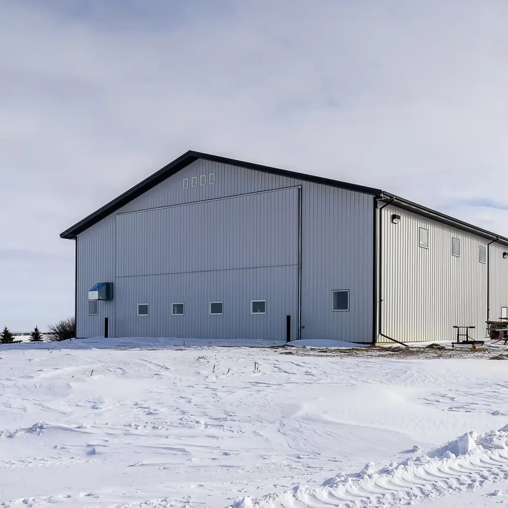 an Iron ore agricultural post-frame shop with three overhead doors and bi-fold door