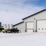 an Iron ore agricultural post-frame shop with three overhead doors and bi-fold door