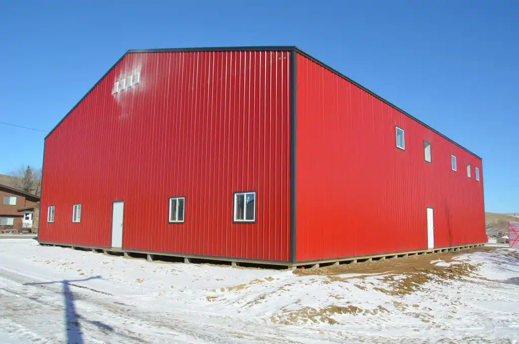 A dark red post-frame commercial fire hall