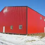 A dark red post-frame commercial fire hall