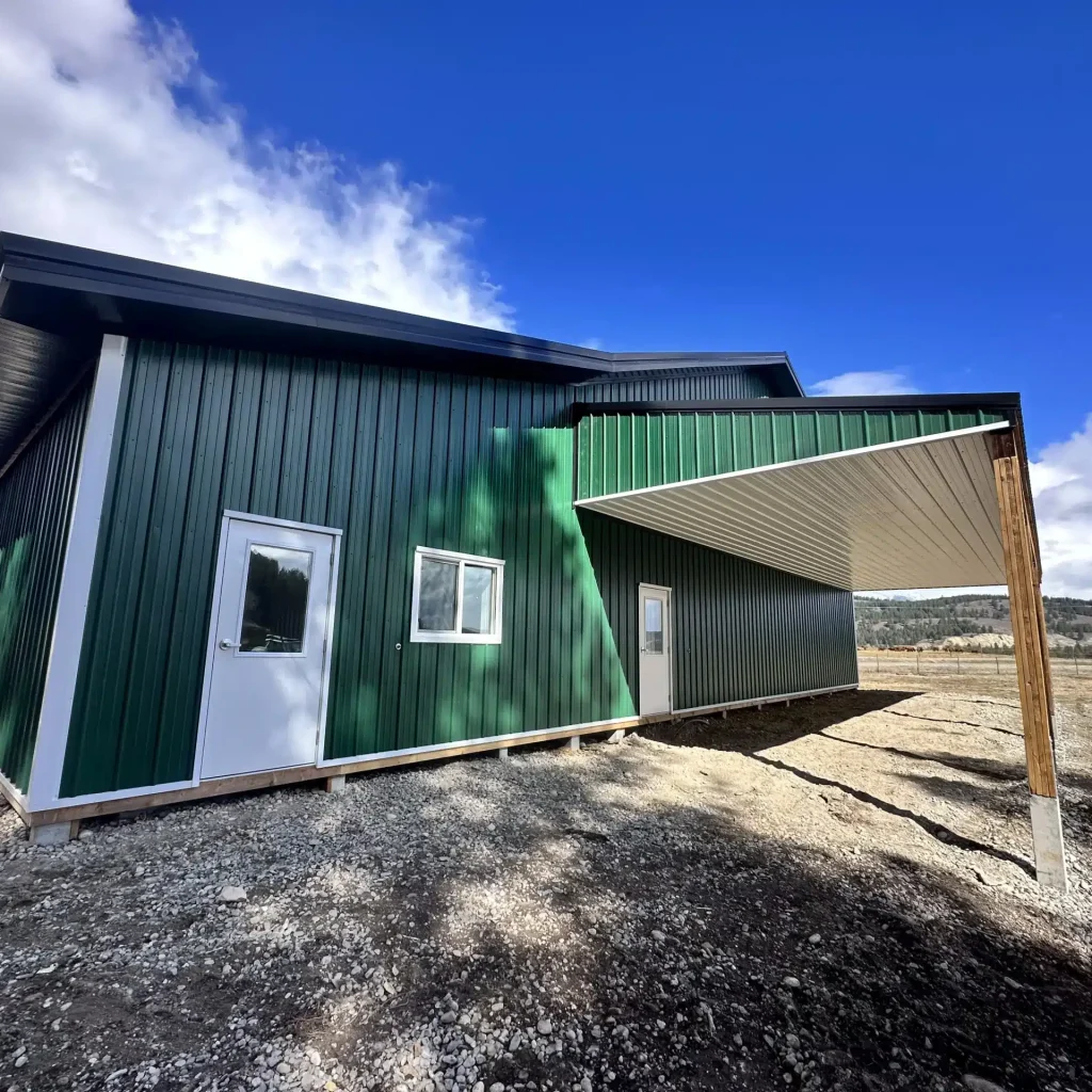 A melchers green lifestyle & Hobby post-frame shop with two overhead doors and soffits