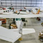 An iron ore post-frame commercial build with a bi-fold door