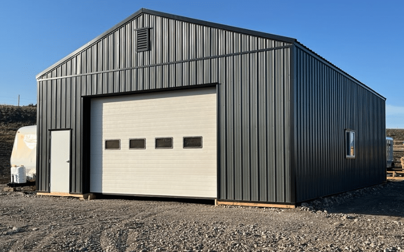 A 30'x40' black Agricultural post-frame Shop with an overhead door