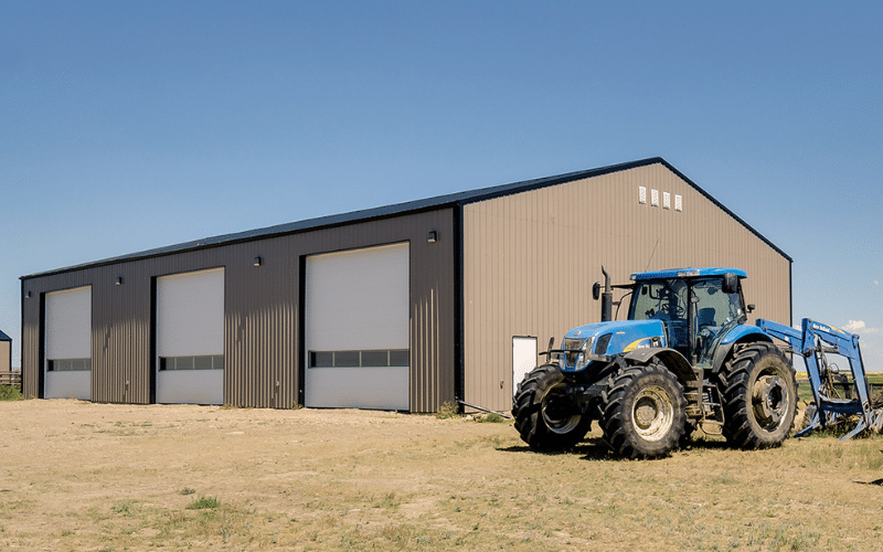 A Buckskin agricultural Post-frame shop with three overhead doors for holding farm equipment