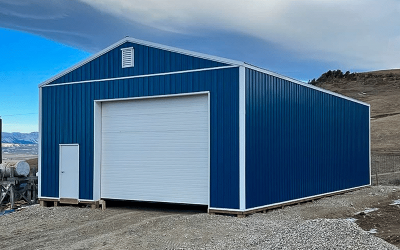 A Heron Blue Agricultural post-frame shop with one overhead door