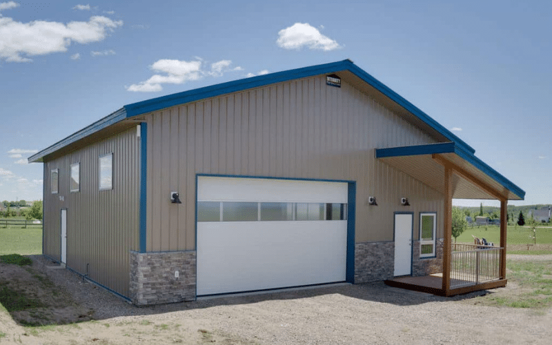 A buckskin lifestyle & Hobby post-frame shop with wainscotting, soffits, and one overhead door