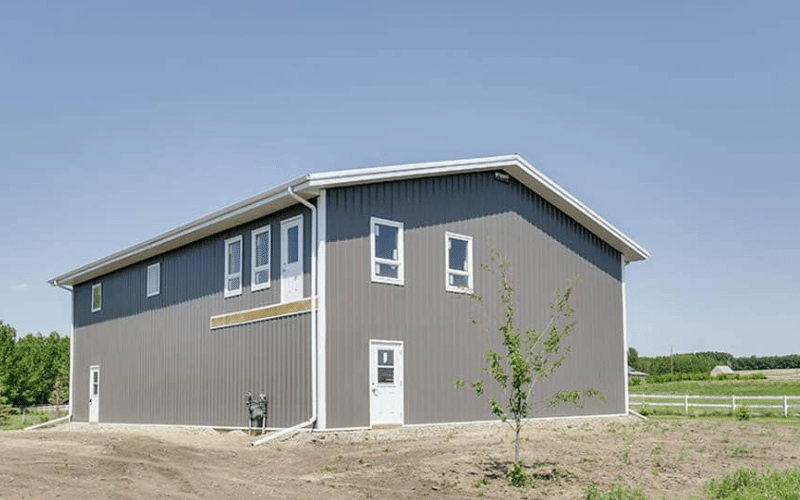 A charcoal lifestyle & Hobby post-frame shop with one chain overhead door