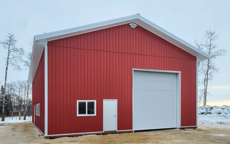 A tile red agricultural post-frame shop with 1 overhead door