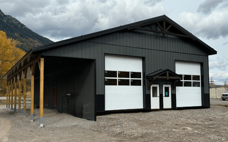A gunmetal lifestyle & hobby post-frame shop with four overhead doors