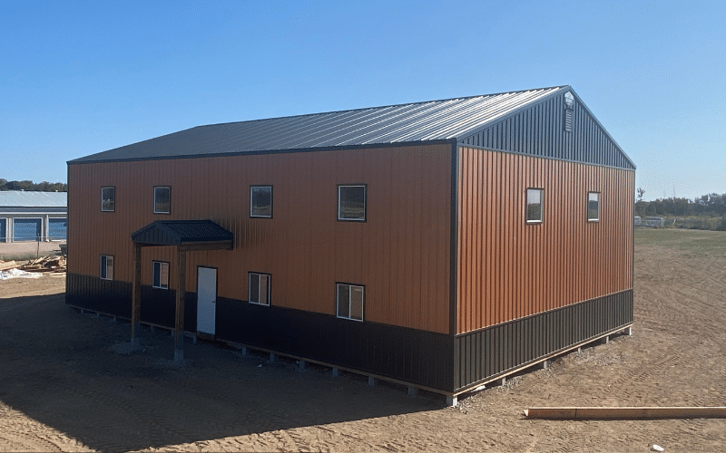 A copper penny post-frame commercial build with black wainscotting