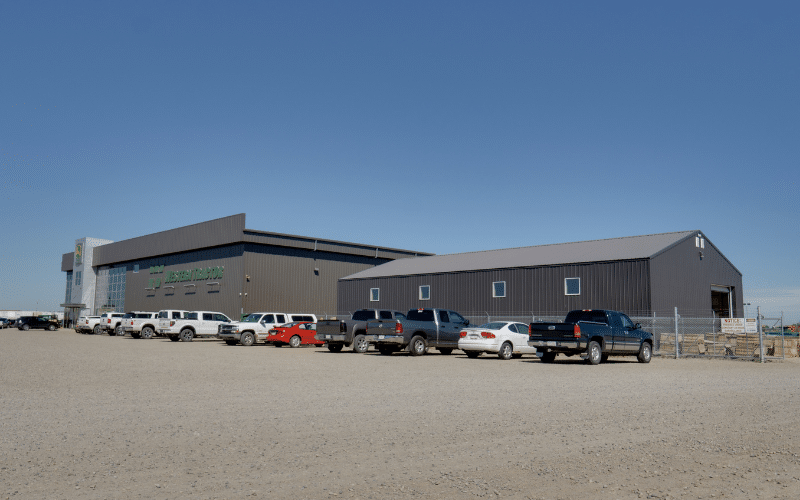 A dark brown post-frame commercial build with two overhead doors