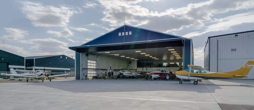An iron ore post-frame commercial build with a bi-fold door