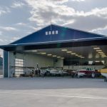An iron ore post-frame commercial build with a bi-fold door