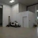 A buckskin post-frame equestrian barn