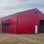 A bright red post-frame agricultural shop