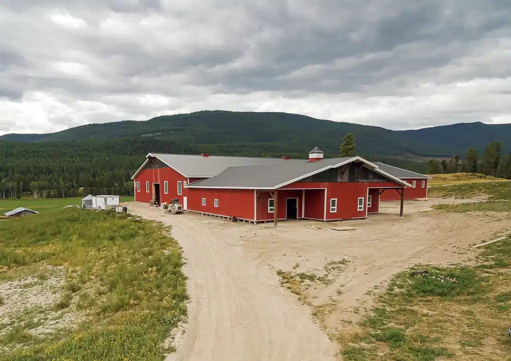 A post-frame equestrian riding arena