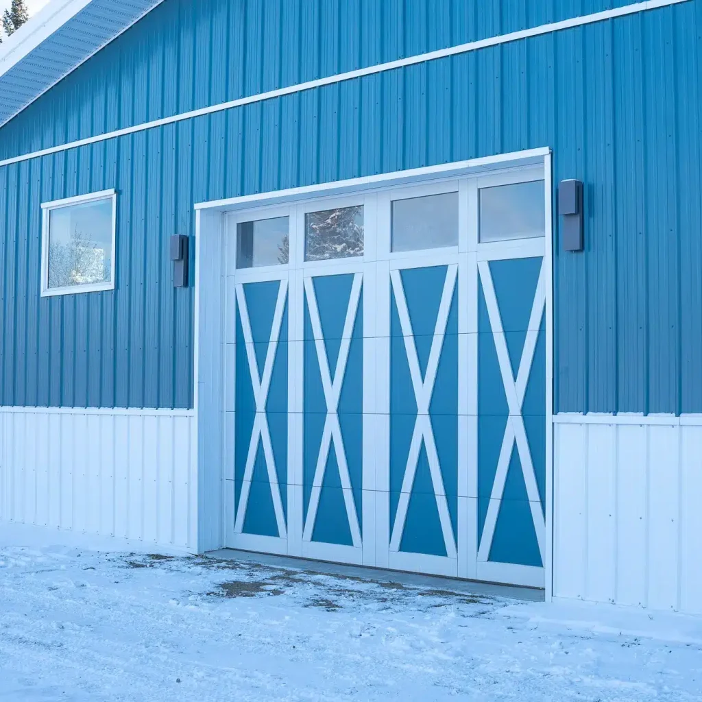A slate blue post-frame equestrian riding arena