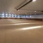 A slate blue post-frame equestrian riding arena