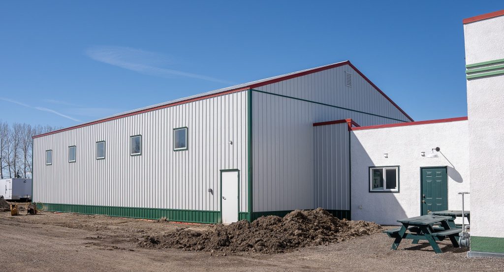 A white white post-frame Agricultural shop and museum.