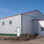 A white white post-frame Agricultural shop and museum.