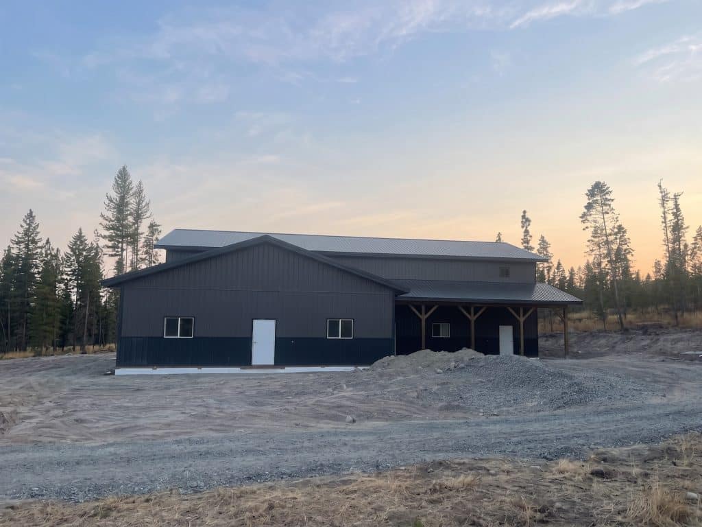 A charcoal post-frame lifestyle & hobby storage building with soffits and wainscotting
