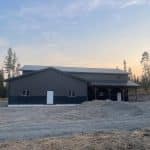 A charcoal post-frame lifestyle & hobby storage building with soffits and wainscotting