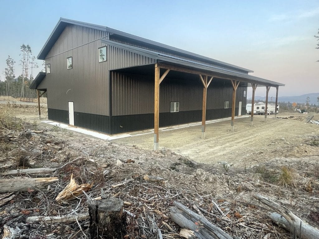 A charcoal post-frame lifestyle & hobby storage building with soffits and wainscotting