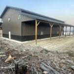 A charcoal post-frame lifestyle & hobby storage building with soffits and wainscotting