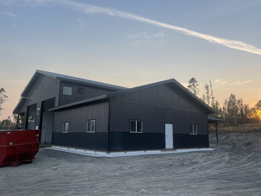 A charcoal post-frame lifestyle & hobby storage building with soffits and wainscotting
