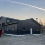 A charcoal post-frame lifestyle & hobby storage building with soffits and wainscotting