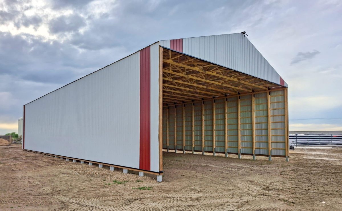 A white white post-frame equestrian Hay Shed