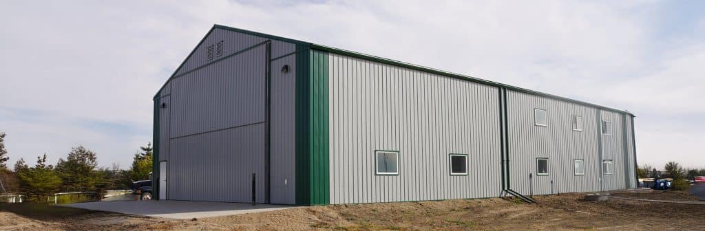 A post-frame agricultural shop with overhead door