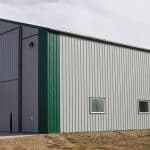 A post-frame agricultural shop with overhead door
