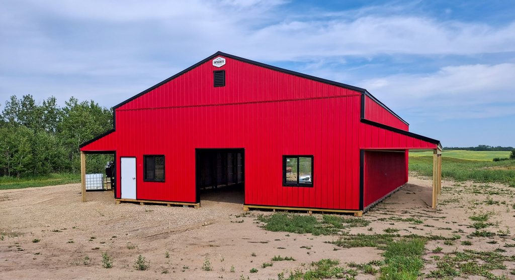 A bright red post-frame agricultural shop