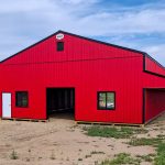 A bright red post-frame agricultural shop