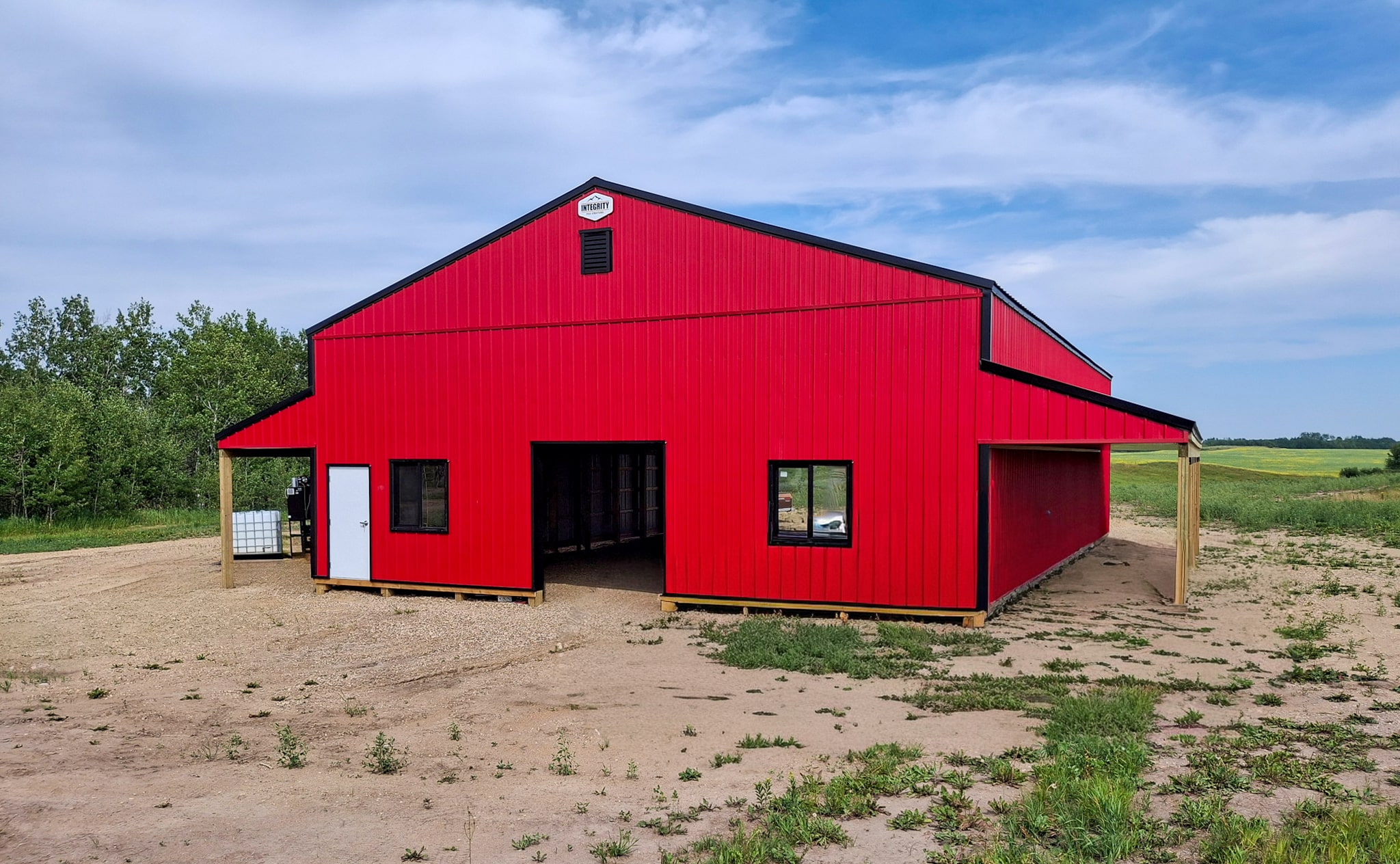 A bright red post-frame agricultural shop
