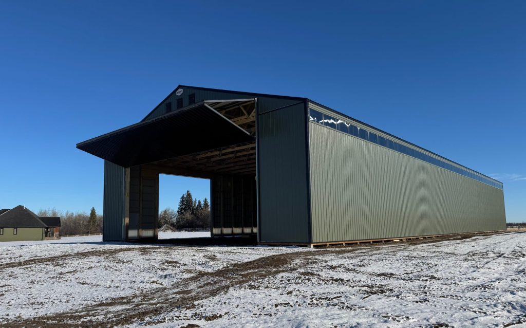 A dark sage post-frame machine shed with sliding doors, overhead doors, and bi-fold doors