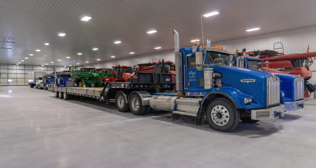 A white white post-frame agricultural machine Shed