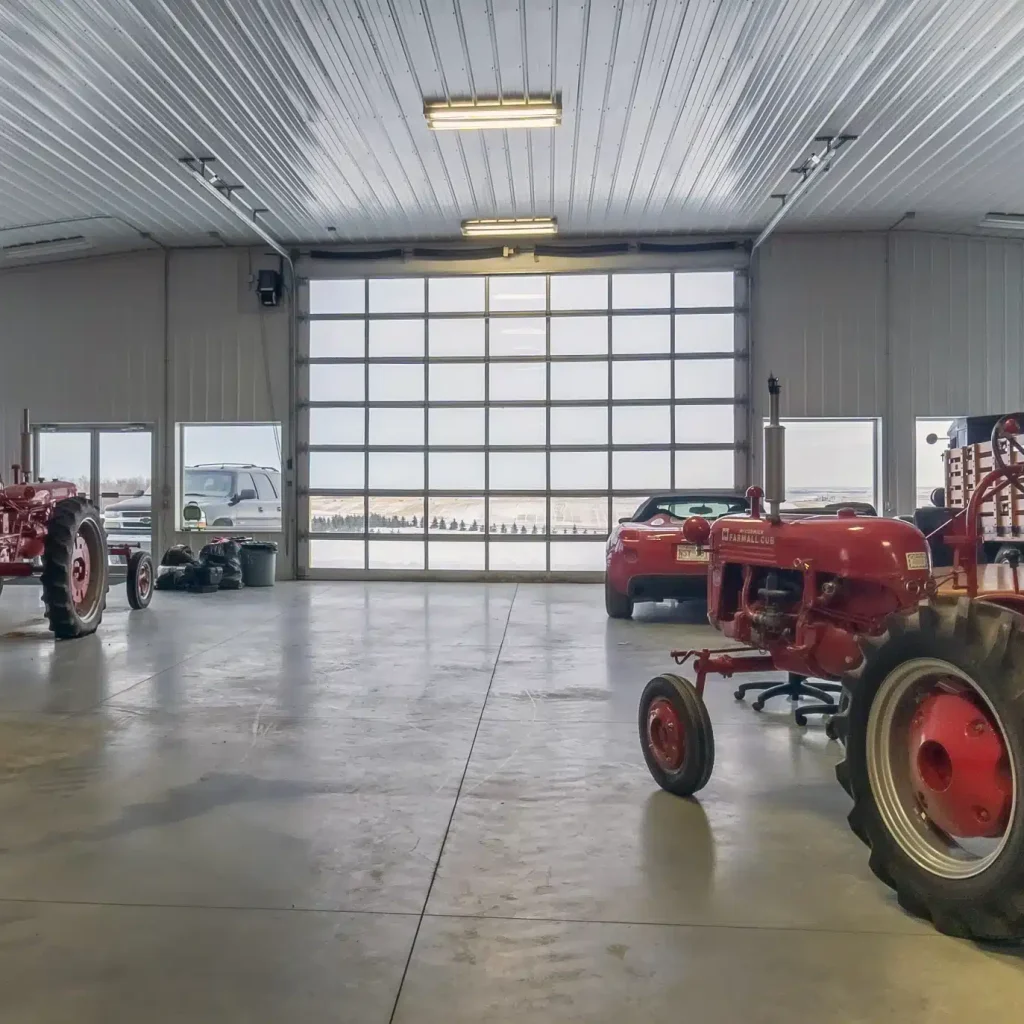 A white white post-frame agricultural machine Shed