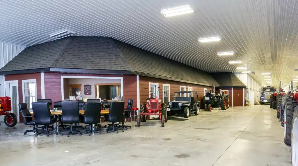 A white white post-frame agricultural machine Shed