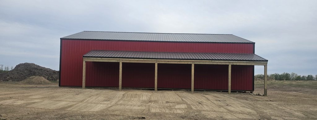 A bright red post-frame agricultural shop
