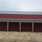 A bright red post-frame agricultural shop