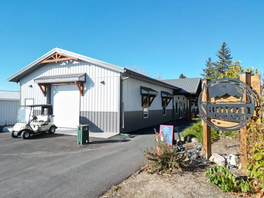 A white white post-frame commercial golf cart storage