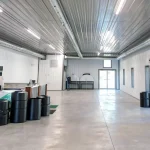 A white white post-frame commercial golf cart storage