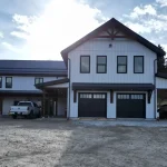 Front view of a white white post-frame barndominium