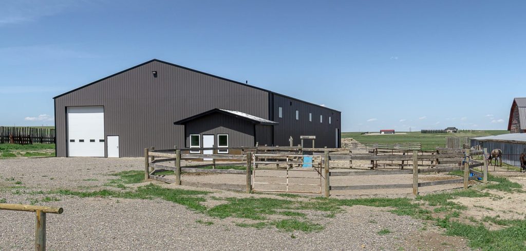 A post-frame riding arena with and overhead door