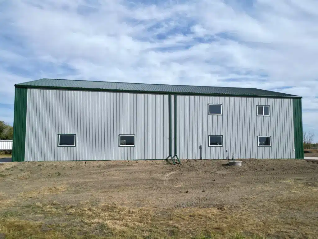 A post-frame agricultural shop with melchers green trim