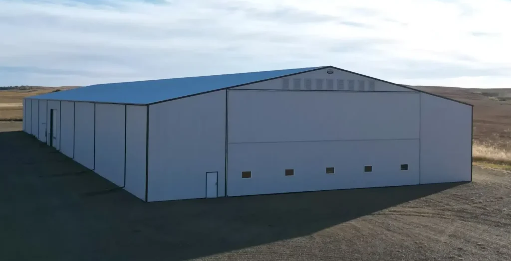 A white white post-frame agricultural storage building
