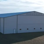 A white white post-frame agricultural storage building