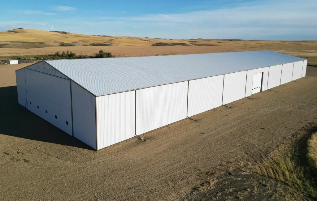 A white white post-frame agricultural storage building